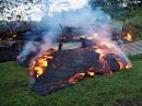 Lava pushed through a fence marking a property boundary early on October 28 in Pahoa on the Big Island of Hawaii. [USGS/HVO photo]